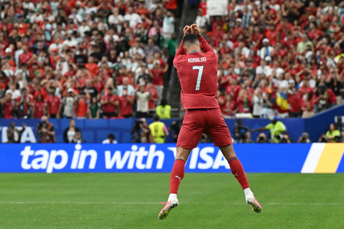 Portugal's forward #07 Cristiano Ronaldo celebrates after scoring the opening goal during the 2026 World Cup Group K football match between Portugal and Uzbekistan at the Houston Stadium in Houston on June 23, 2026. (Photo by RONALDO SCHEMIDT / AFP)