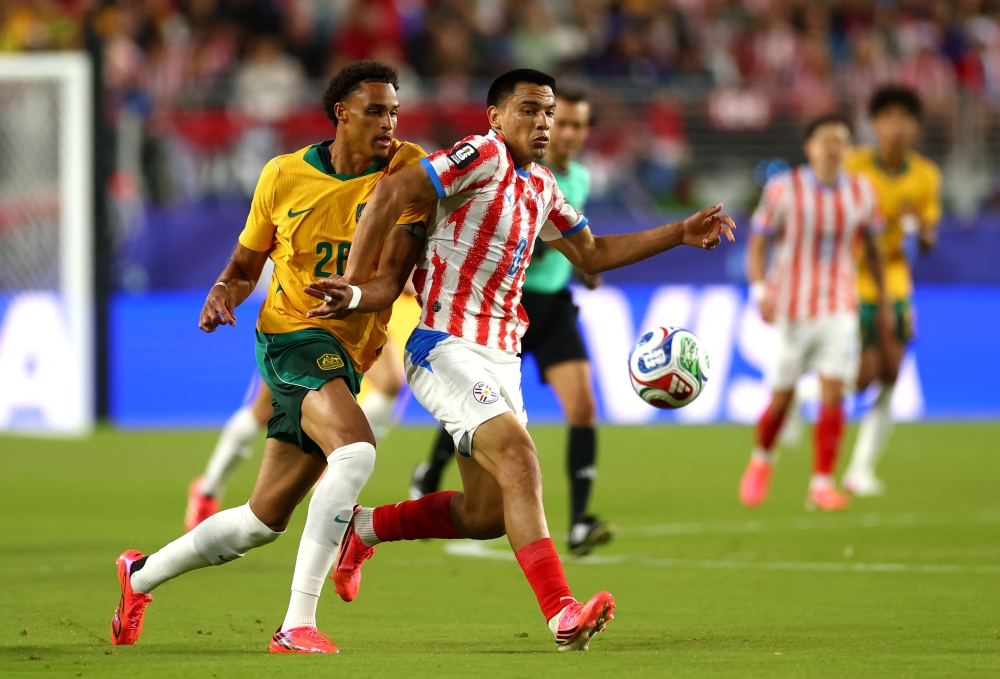 Tete Yengi #26 of Australia competes for the ball against Diego Gomez #8 of Paraguay. Dean Mouhtaropoulos/Getty Images/AFP