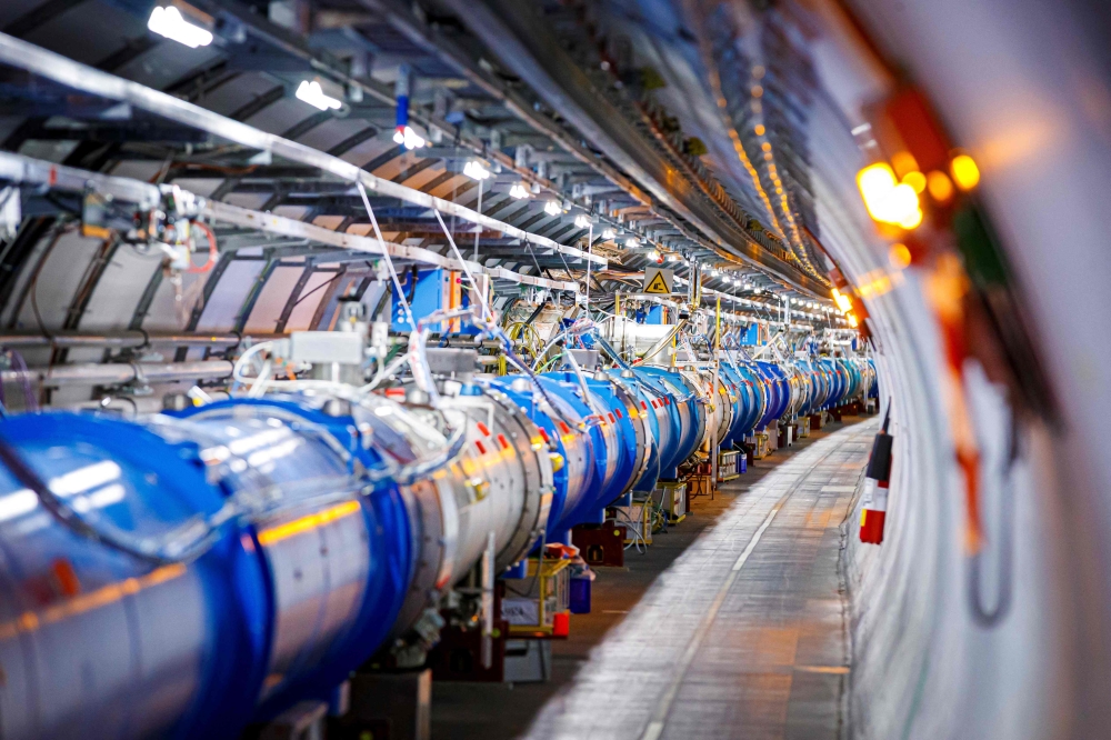 (Files) The 1232 dipole magnets that bend the path of accelerated protons are pictured in the Large Hadron Collider (LHC) in a tunnel of the European Organisation for Nuclear Research (CERN), during maintenance works on February 6, 2020 in Echenevex, France, near Geneva. (Photo by Vlentin Flauraud / AFP)
