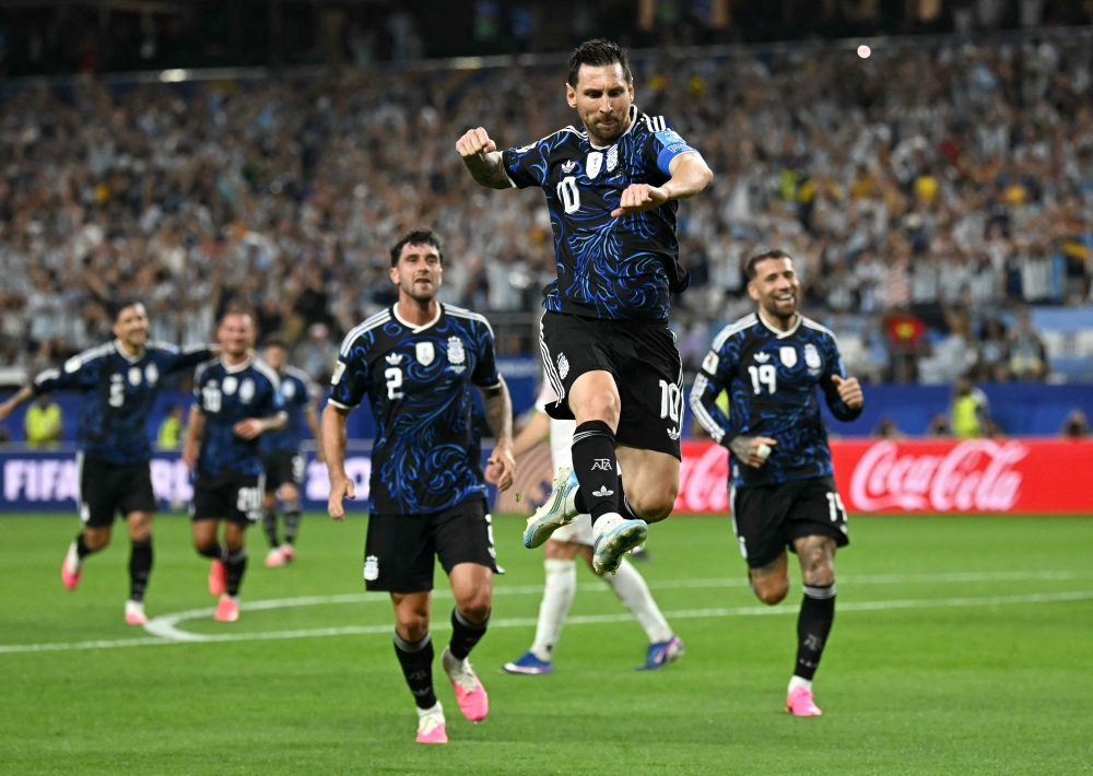 Argentina's forward #10 Lionel Messi celebrates scoring his team's third goal. (Photo by Paul Ellis / AFP)
