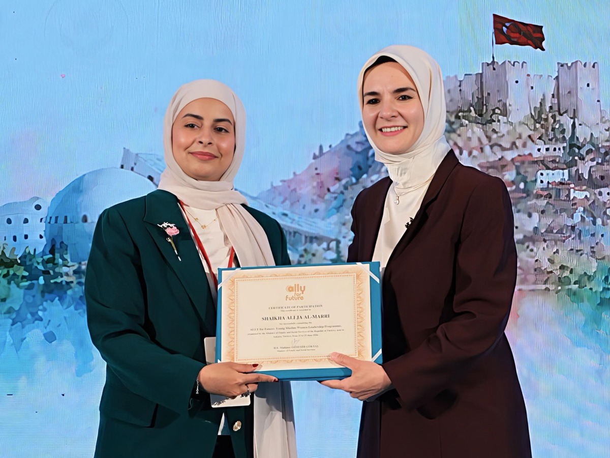 Head of the Family Affairs Section at the Ministry of Social Development and Family Sheikha Ali Al Marri receives a certificate during the event.