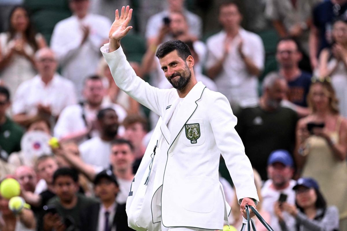 Serbia's Novak Djokovic waves as he leaves the court after winning Greece's Stefanos Tsitsipas during their men's singles second round tennis match on the third day of the 2026 Wimbledon Championships at The All England Lawn Tennis and Croquet Club in Wimbledon, southwest London, on July 1, 2026. (Photo by Kirill KUDRYAVTSEV / AFP)
