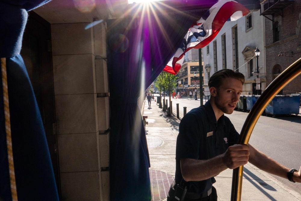 People walk through downtown Philadelphia after news that the Semiquincentennial Independence Day Parade has been canceled due to extreme heat in Philadelphia, Pennsylvania. (Photo by SPENCER PLATT / AFP)