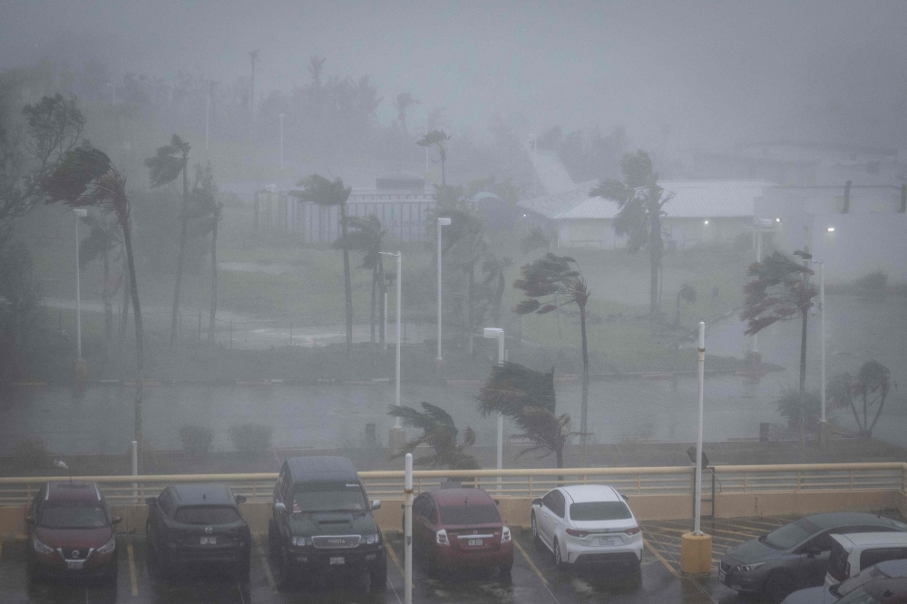 Strong wind brought by Super Typhoon Bavi hits Guam on July 6, 2026. (Photo by Yuichi YAMAZAKI / AFP)
