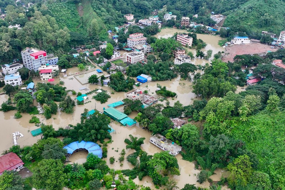 This aerial photograph shows partially submerged residential buildings following heavy rains in Bangladesh's Bandarban town on July 11, 2026. (Photo by Syed Amir Hosain Masum / AFP)