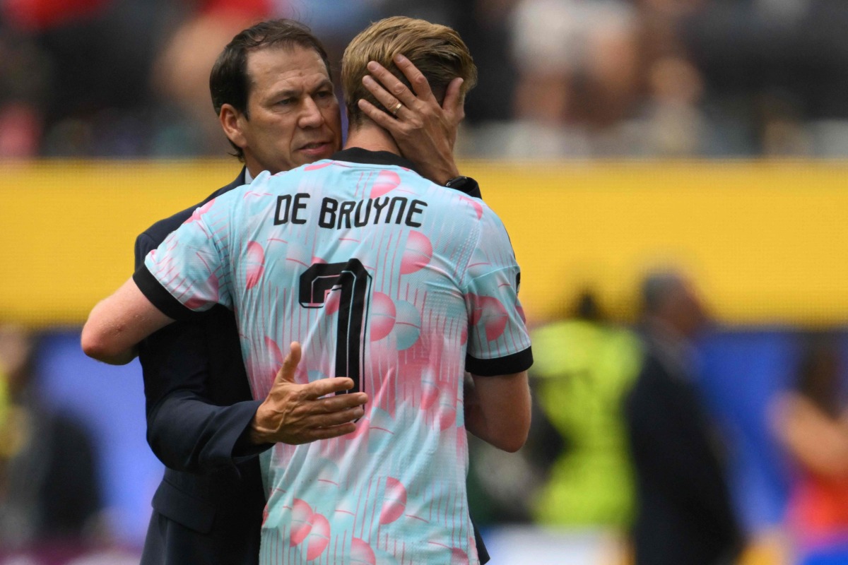 Belgium’s head coach Rudi Garcia and midfielder Kevin De Bruyne hug after the match. PICS: AFP