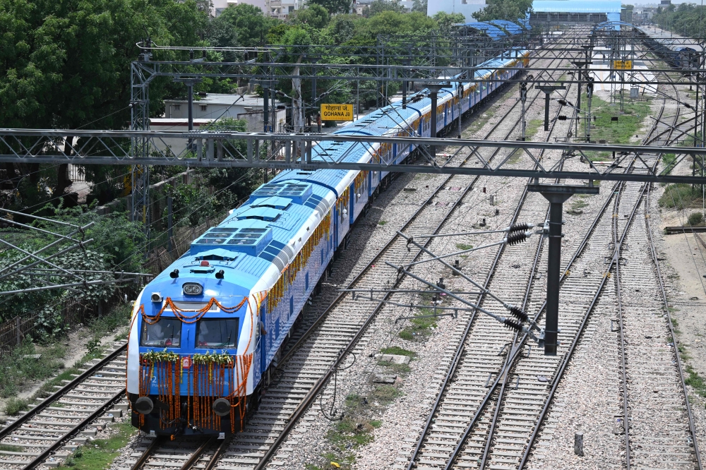 Indian Railways' hydrogen-powered train runs through Haryana's Gohana city on July 17, 2026. (Photo by Arun Sankar / AFP)