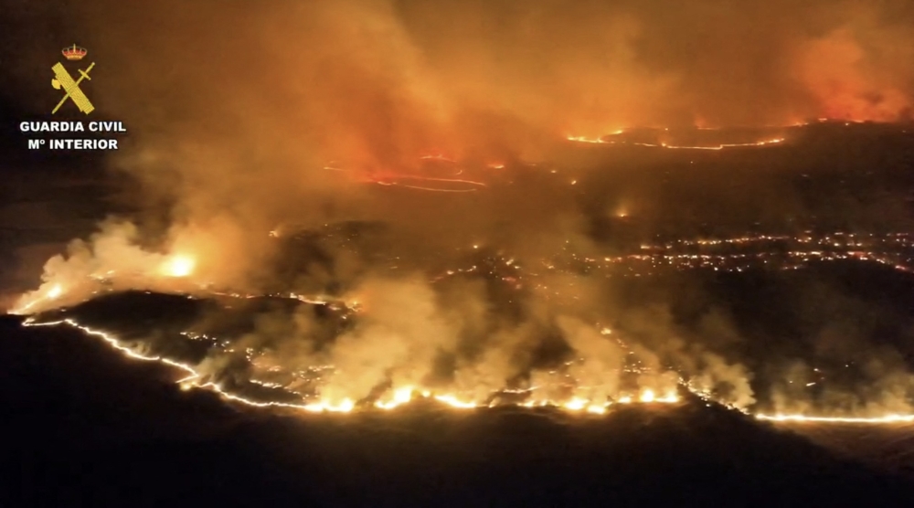 This screen grab taken from handout aerial video footage released on July 18, 2026 by Spain's Pegaso unit of the Guardia Civil shows a massive wildfire, in Cinco Villas area, near Zaragoza, in a sparsely populated part of the Aragon region in northeastern Spain. (Photo by Handout / Spanish Guardia Civil / AFP)