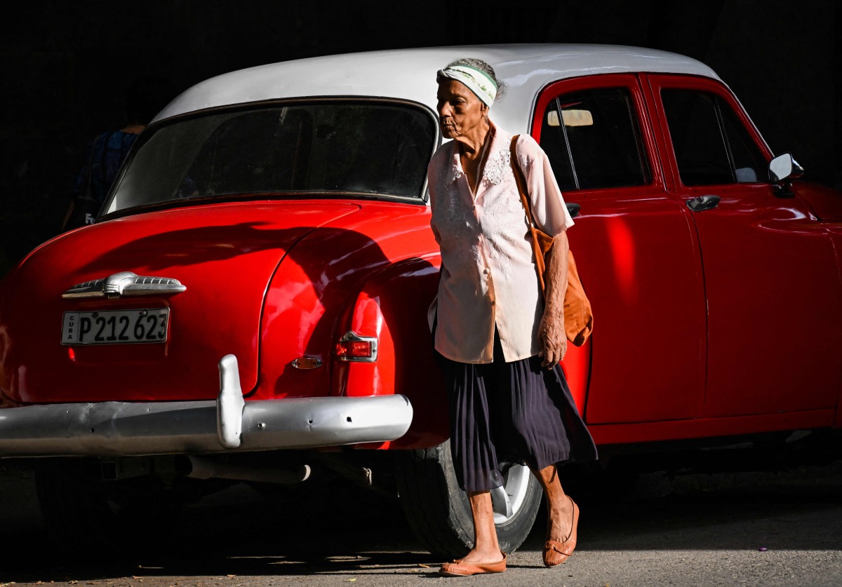 (FILES) An elderly woman walks in a street of Havana, on June 3, 2025. (Photo by YAMIL LAGE / AFP)
