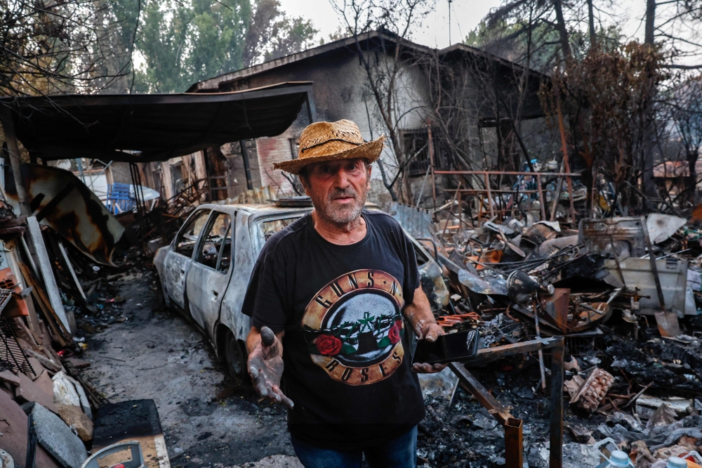 Jose Fernandez is pictured at his burnt-out home following a devastating wildfire in Pelayos de la Presa, 65 kilometers west of Madrid, on July 28, 2026. (Photo by Pierre-Philippe Marcou / AFP)