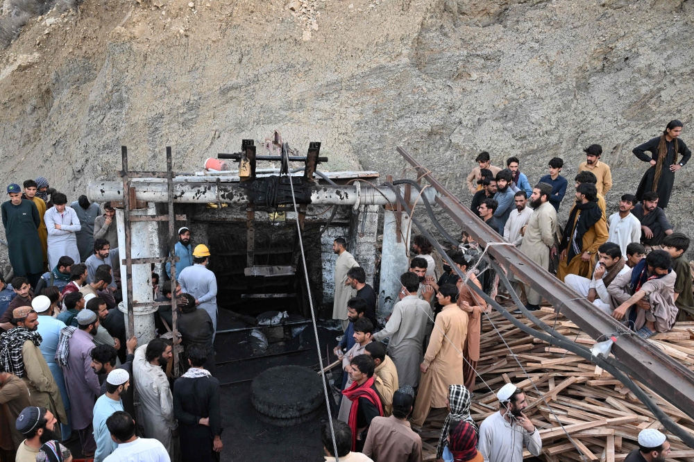 Coal miners and relatives gather at the entrance of a coal mine after it collapsed in the Surange area, some 50 kilometres east of Quetta, on July 30, 2026. (Photo by Banaras Khan / AFP)