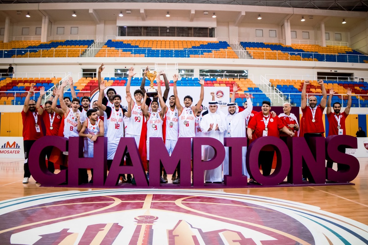 Bahrain players celebrate with their trophy and medals.