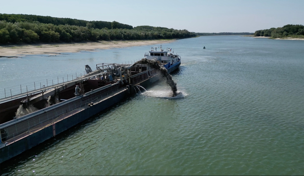 An aerial view shows a dredger deployed to deepen the navigable channel due to the low level of Danube near Capidava village, on August 12, 2026.(Photo by Daniel MIHAILESCU / AFP) 