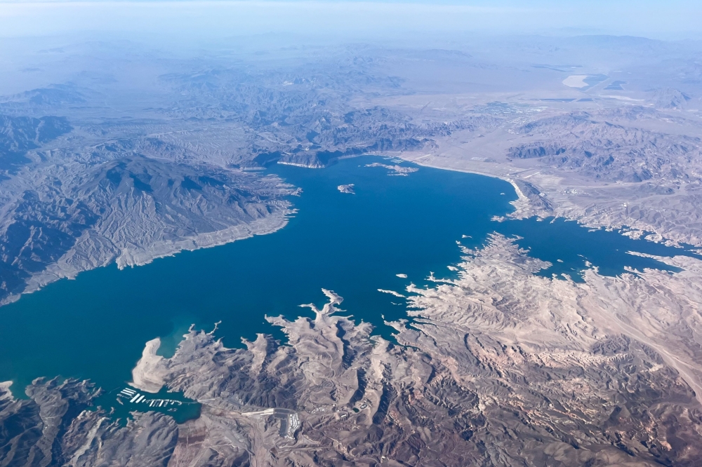 This aerial photo taken on August 6, 2026, shows low water levels in Lake Mead in Nevada. In mid-July, the combined water levels of Lake Powell and Lake Mead, the two largest reservoirs in the United States and both fed by the Colorado River, reached their lowest levels in over 60 years. The Colorado River provides drinking water for more than 40 million people and fuels hydropower across seven states. (Photo by Eva Claire HAMBACH / AFP)