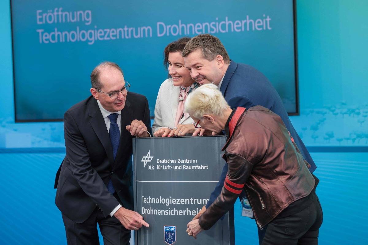 (L-R) German Interior Minister Alexander Dobrindt, German Minister for Research, Technology and Aerospace Dorothee Baer, Saxony-Anhalt's State Premier Sven Schulze and the Chairwoman of the DLR Executive Board Anke Kaysser-Pyzalla take part in the opening of the new Drone Safety Technology Center at the Cochstedt site of the German Aerospace Center (DLR), eastern Germany on August 18, 2026. (Photo by Ronny HARTMANN / AFP)