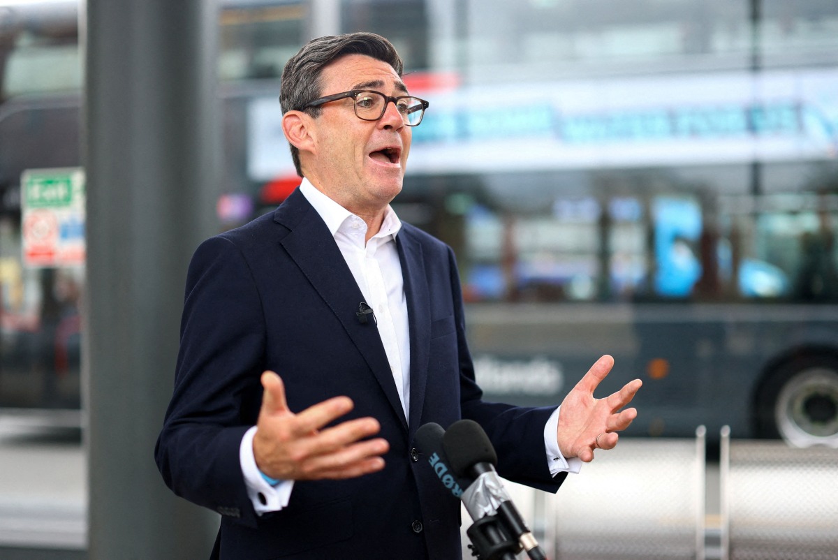 Britain's Prime Minister Andy Burnham speaks to the media, during his visit to Wolverhampton Bus Station, in Wolverhampton, central England on August 18, 2026. (Photo by Hannah McKay / AFP)