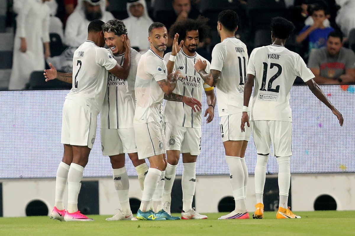 Al Sadd players celebrate during their match against Al Ahli.