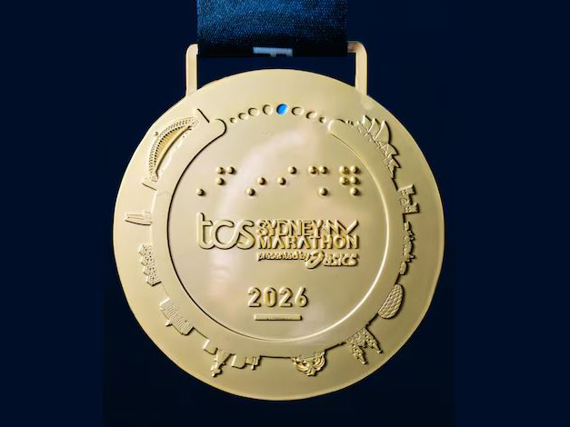 Eagle-eyed people noticed the wrong stadium depicted at the bottom right of the commemorative medal for the 2026 Sydney Marathon. (Photo: Sydney Marathon/ABCNews)