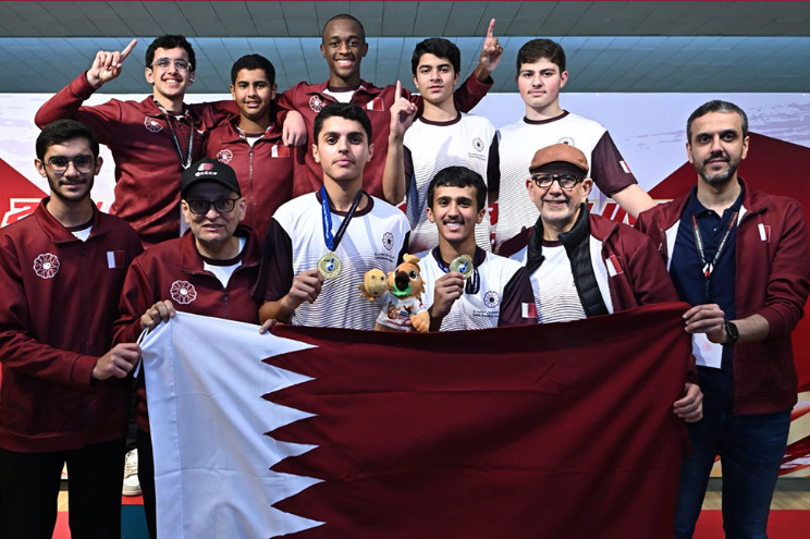 Qatar's players and officials pose for a group photo. 