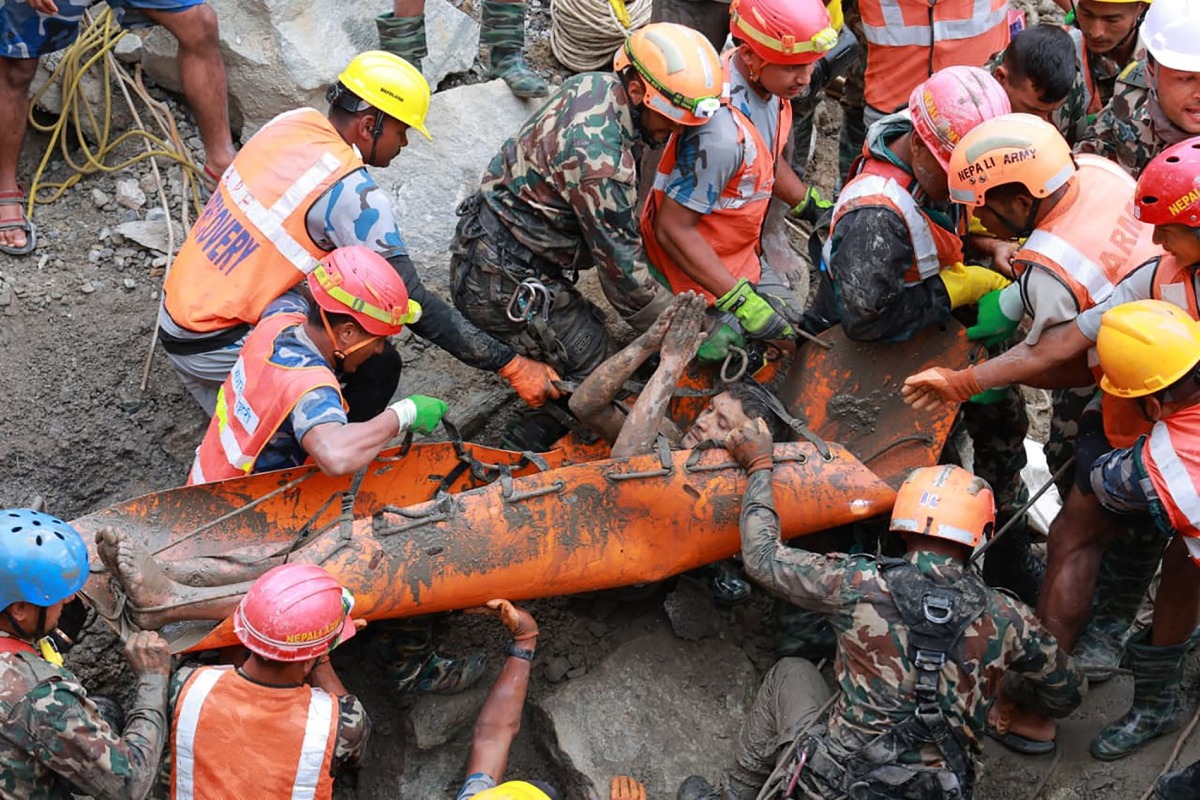This handout photograph taken and released by the Nepal Army on September 4, 2026 shows army personnel carrying a worker who was trapped inside a tunnel, during a rescue operation at Trishuli-3A Hydropower Project in Nepal's Rasuwa district. Photo by Handout / NEPAL ARMY / AFP