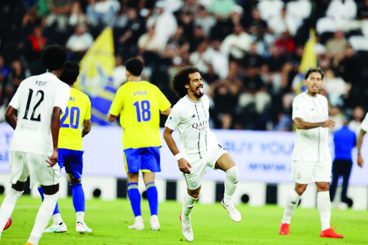 Al Sadd's Akram Afif (second right) celebrates after scoring a goal.