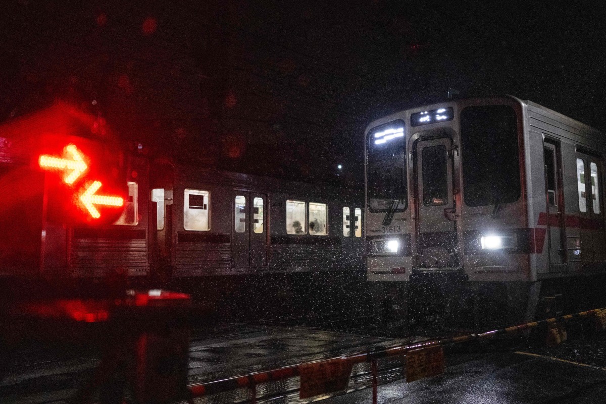 Trains cross during a heavy rainstorm in Tokyo on September 6, 2026 after Japan's weather agency warned of intense rain around the region. (Photo by Andrew CABALLERO-REYNOLDS / AFP)