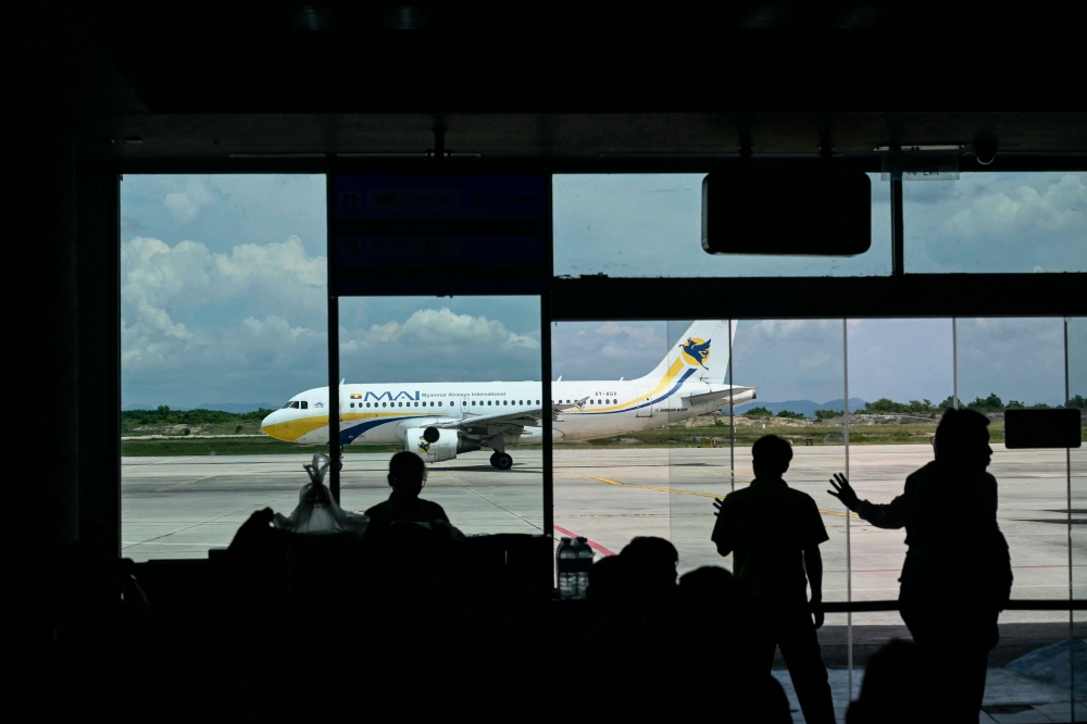 (FILES) A Myanmar Airways International passenger plane is parked at the Mandalay International Airport in Mandalay on September 18, 2025.  (Photo by Sai Aung MAIN / AFP)