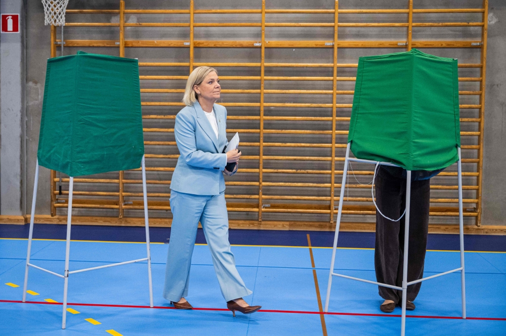 Social Democratic Party leader Magdalena Andersson walks on her way to cast her vote at a polling station in a school during Sweden's general election, in Nacka on September 13, 2026. (Photo by Jonathan Nackstrand / AFP)