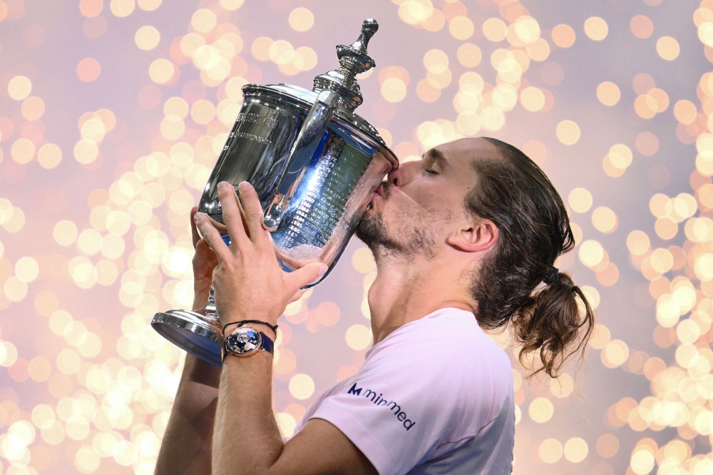 Germany's Alexander Zverev kisses the trophy after defeating USA's Ben Shelton in the men's singles final tennis match on day fifteen of the US Open tennis tournament at the USTA Billie Jean King National Tennis Center in New York on September 13, 2026. (Photo by ANGELA WEISS / AFP)