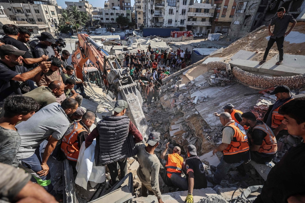 Rescuers excavate rubble to retrieve bodies from a collapsed building in the Tal al-Hawa area of Gaza City on September 16, 2026. (Photo by Omar Al-Qattaa / AFP)