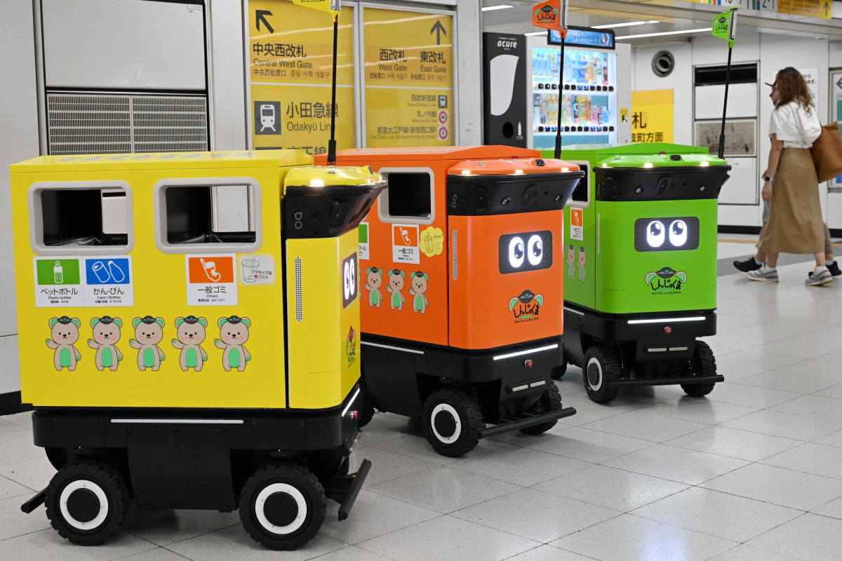 Mobile robotic trash bins are pictured during testing at the Shinjuku Station transport complex in Tokyo on September 18, 2026. Photo by Toshifumi KITAMURA / AFP