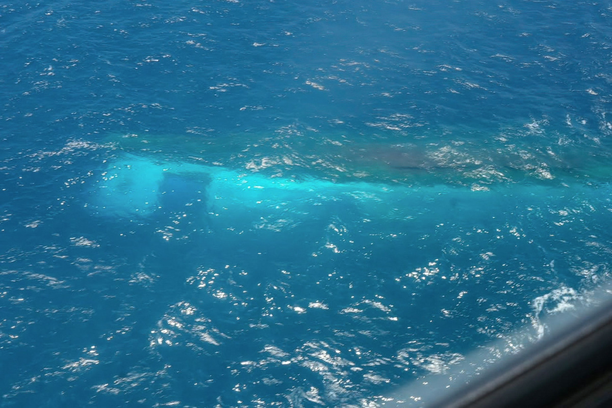 This handout picture taken on September 17, 2026, and released on September 18, 2026 by the Indonesian Navy shows the passenger ship Virgo Transport 8 which capsized in the Java Sea waters, as seen from a Navy vessel. (Photo by Handout / INDONESIAN NAVY / AFP)