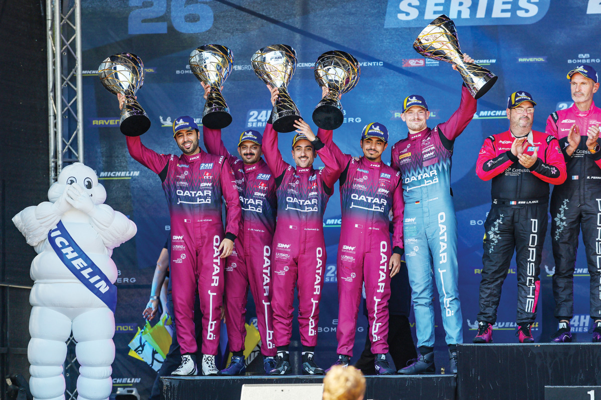 Team Qatar drivers celebrate on the podium. 