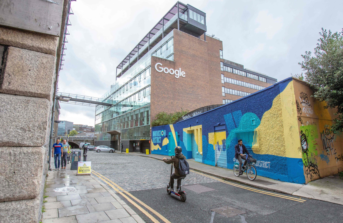  Members of the public pass the offices of Google in the business and financial sector of Dublin, Ireland on October 7, 2021. Photo by PAUL FAITH / AFP