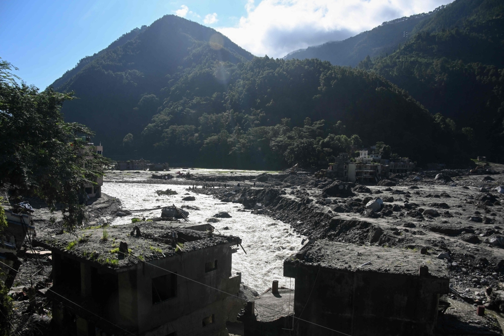 A general view shows damaged houses covered in sludge in the aftermath of the August 26 flash flood, at Betrawati Bazaar in Nepal's Rasuwa district on September 28, 2026. (Photo by Prakash Mathema / AFP)