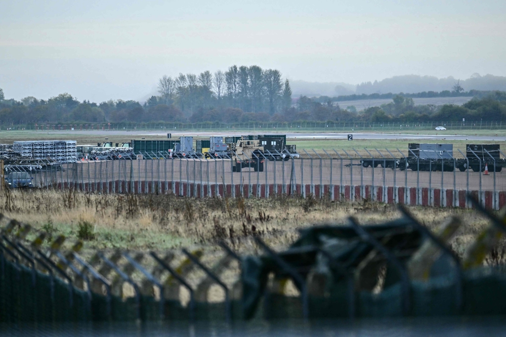 An armoured vehicle (C) patrols the interior at RAF Fairford base in Fairford, south-west England on September 28, 2026. (Photo by Ben Stansall / AFP)