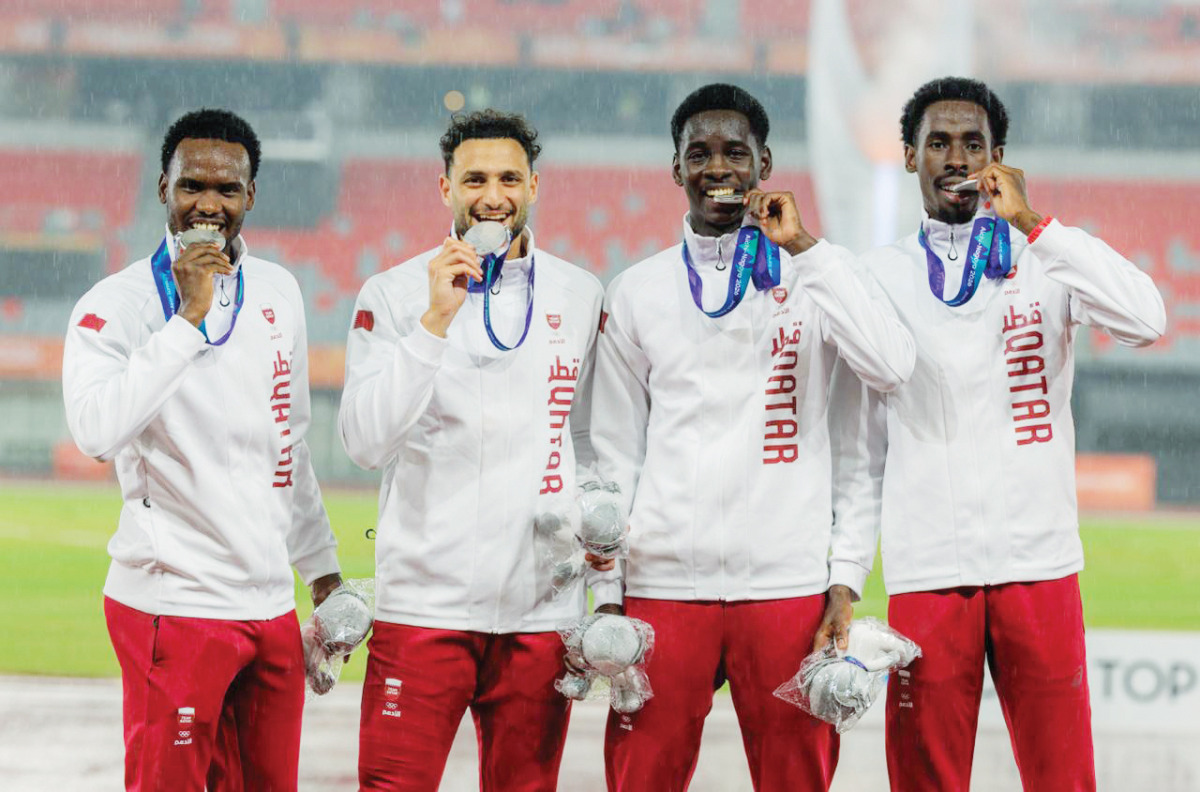 Qatar’s 4x400m relay quartet of Ammar Ibrahim, Bassem Hemeida, Youssef Djibrine and Ismail Abakar celebrate on the podium.