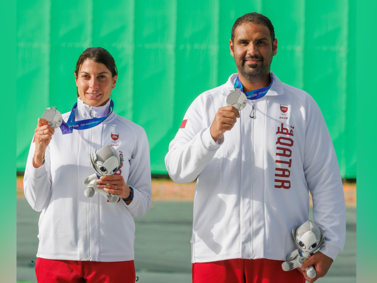 Qatar's Ray Bassil and Mohammed Al-Rumaihi celebrate with their medals on the podium. 
