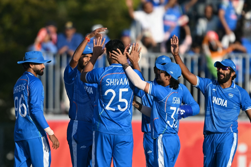 India players celebrate the dismissal of Pakistan's Saim Ayub during the men's cricket final match between Pakistan and India during the 2026 Asian Games at the Korogi Athletic Park in Nisshin on October 3, 2026. (Photo by Andrew Caballero-Reynolds/ AFP)