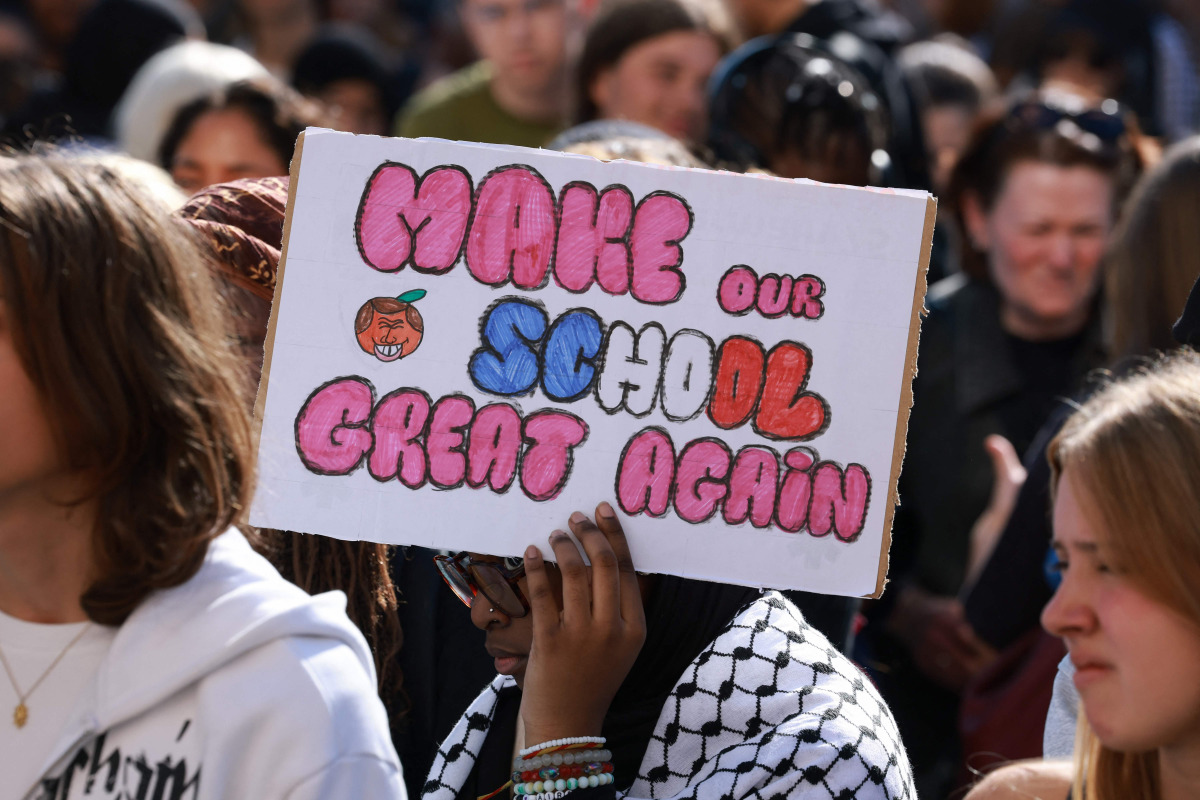 A high school student holds a placard during a gathering amid a nationwide protest movement over school conditions in Saint-Denis, north of Paris, on October 4, 2026. Photo by Kenzo TRIBOUILLARD / AFP