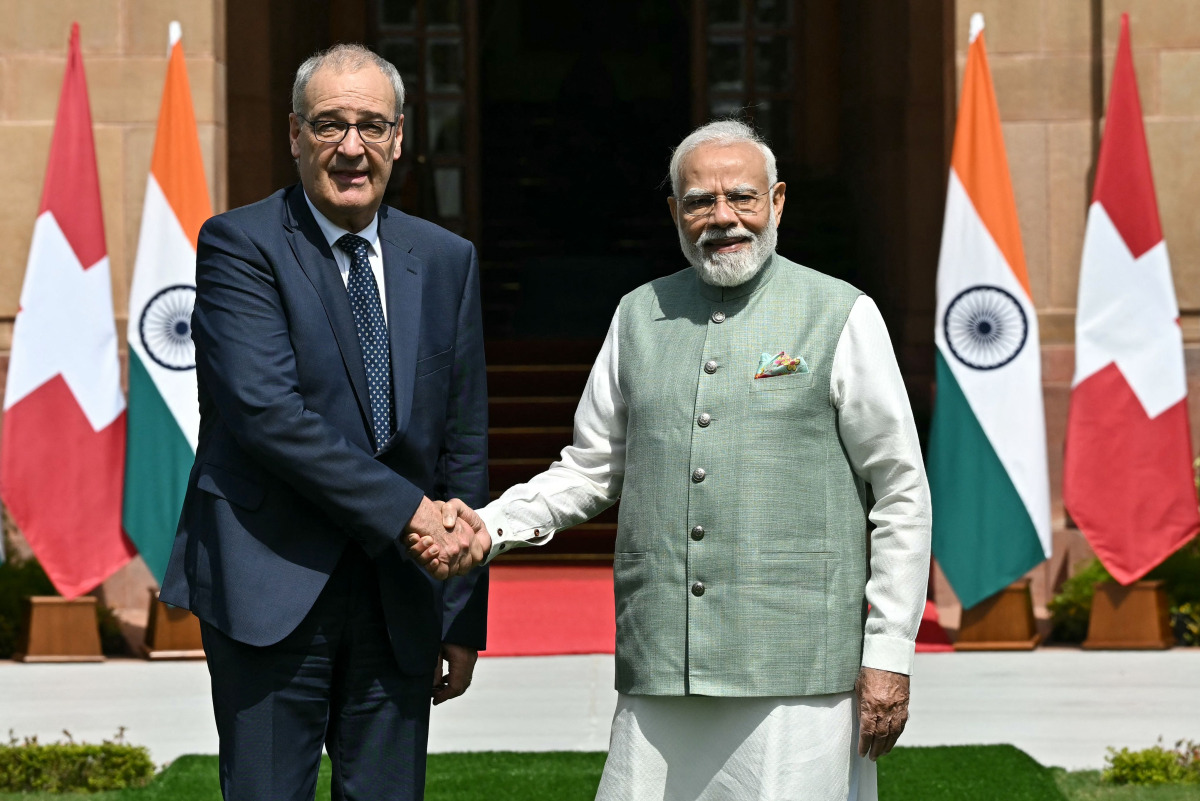 India's Prime Minister Narendra Modi (R) and Switzerland's President Guy Parmelin shake hands before their meeting at the Hyderabad House in New Delhi on October 5, 2026. (Photo by Sajjad HUSSAIN / AFP)