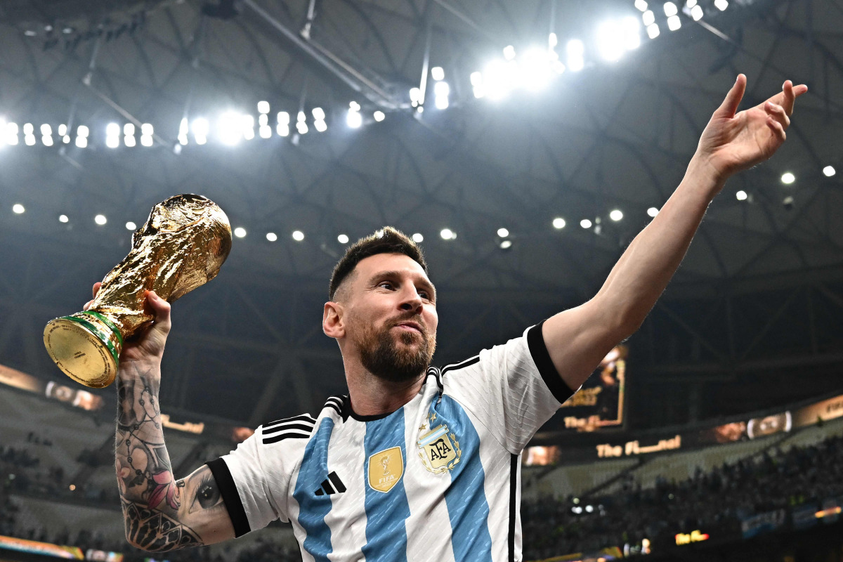 Argentina's captain and forward #10 Lionel Messi pose with the FIFA World Cup Trophy after Argentina won the Qatar 2022 World Cup final football match between Argentina and France at Lusail Stadium in Lusail, north of Doha on December 18, 2022. Photo by Anne-Christine POUJOULAT / AFP