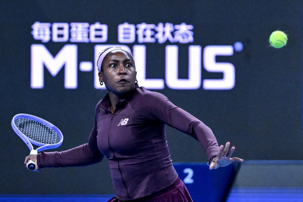US Coco Gauff hits a return to China's Sun Xinran during their women's singles match at the China Open tennis tournament in Beijing on October 5, 2026. (Photo by Adek Berry / AFP) 