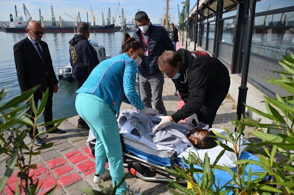 An injured crew member from a ship struck by drones in Bulgaria's exclusive economic zone is moved on a stretcher after he was rescued, at the Varna harbour on October 6, 2026.  (Photo by AFP)
 