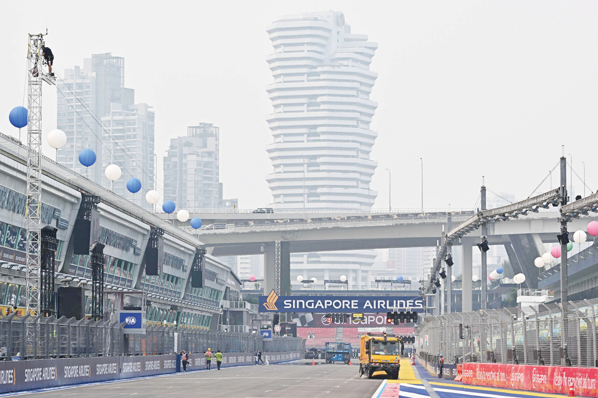Air pollution is seen across the skyline as people prepare the street circuit before the Formula One Singapore Grand Prix night race.