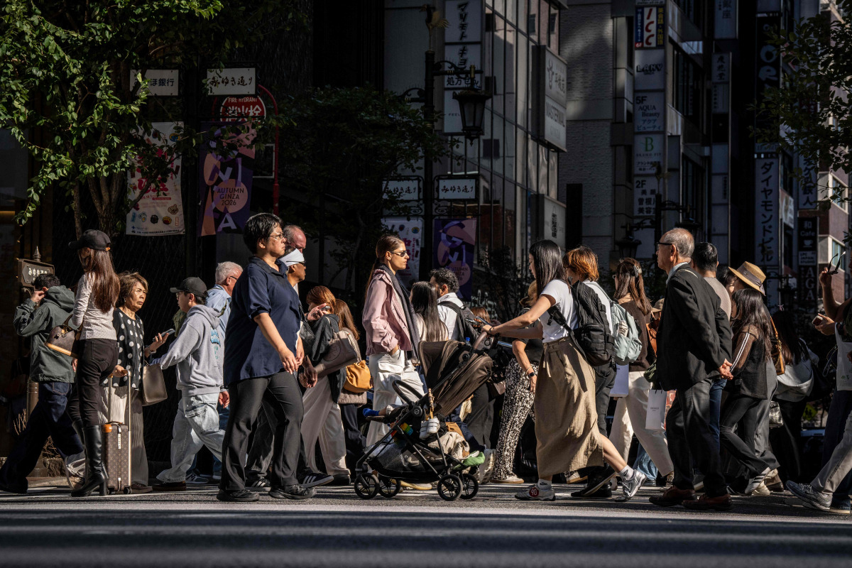 People cross a street in Ginza area of Tokyo on October 8, 2026. (Photo by Yuichi YAMAZAKI / AFP)