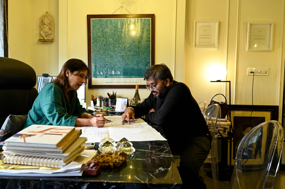 Conservation architect Abha Narain Lambah (L) discussing a project design with an employee in Mumbai. (Photo by Indranil Mukherjee / AFP)