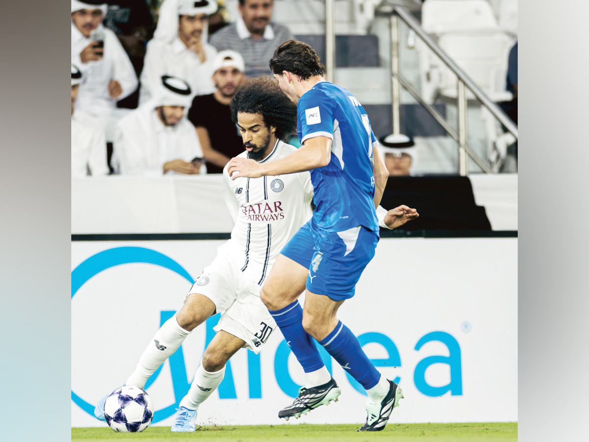 Al Sadd's Akram Afif (left) controls the ball during the match.