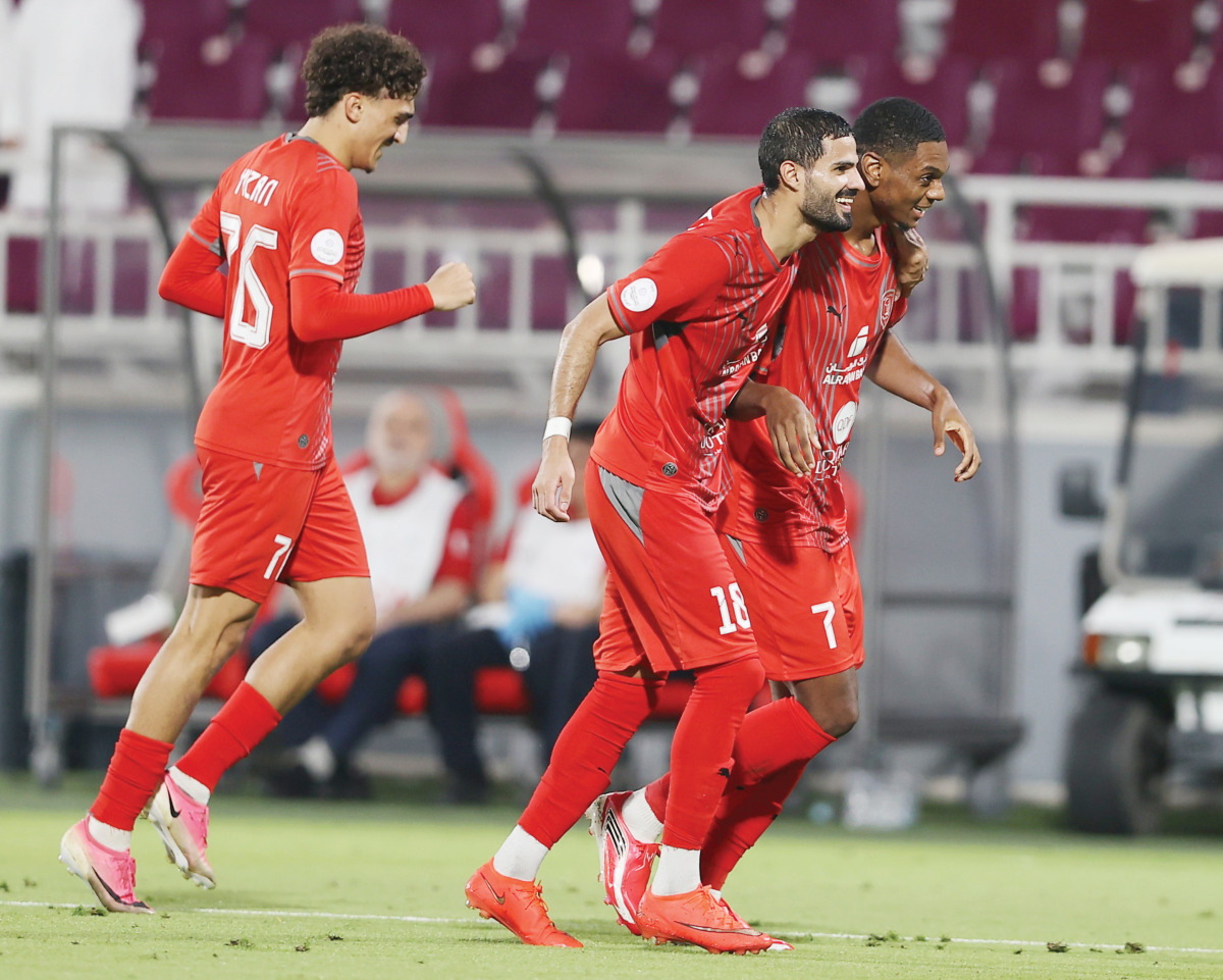 Al Duhail's Sekou Oumar Yansane (right) celebrates with teammates.