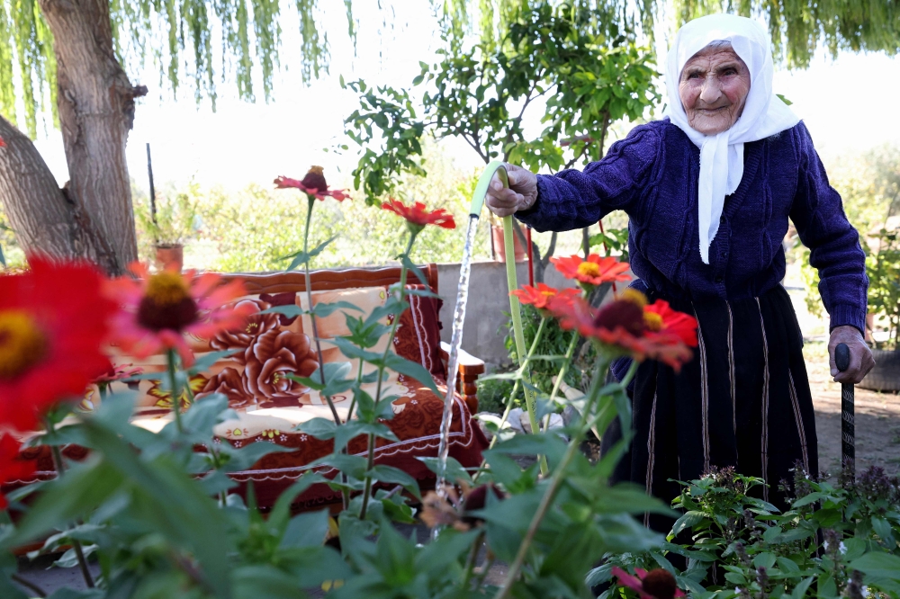 The 117-year-old Qamile Marra poses during an interview with AFP in the garden of her home in the village of Ferras, on October 3, 2026.(Photo by Adnan Beci / AFP)
 